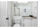 Bathroom with visible vents, toilet, vanity, and a shower with curtain