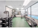 Workout area featuring a drop ceiling and visible vents