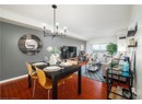 Dining space with a chandelier, wood finished floors, visible vents, and baseboards