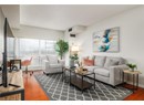 Living area featuring baseboards, wood finished floors, and visible vents
