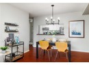 Dining space with baseboards, a chandelier, and dark wood-style floors