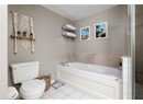 Full bath featuring a bath, toilet, and tile patterned flooring