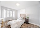 Bedroom featuring visible vents, baseboards, a textured ceiling, and wood finished floors