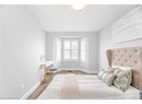Bedroom with visible vents, baseboards, and wood finished floors