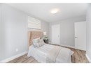 Bedroom with baseboards, a textured ceiling, and wood finished floors