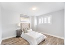 Bedroom featuring a textured ceiling, wood finished floors, and baseboards