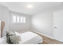 Bedroom featuring baseboards, wood finished floors, and a textured ceiling