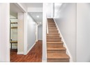 Stairway with baseboards, recessed lighting, and wood finished floors