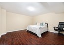 Bedroom with baseboards and wood finished floors