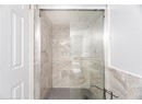 Full bath featuring a shower stall