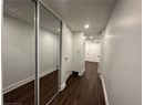 Corridor with baseboards, dark wood-style flooring, and recessed lighting