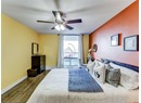 Bedroom featuring wood finished floors, baseboards, and a ceiling fan