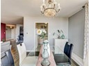 Dining space with a chandelier, wood finished floors, and baseboards