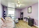 Living area featuring light wood finished floors, a ceiling fan, and baseboards