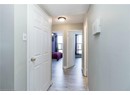 Corridor featuring light wood-style floors and baseboards