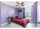 Bedroom with wood finished floors, ceiling fan, and baseboards