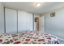 Bedroom featuring a closet, baseboards, and wood finished floors