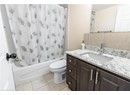 Full bathroom featuring toilet, shower / bath combination with curtain, tile patterned floors, and vanity