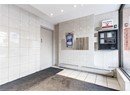 Bathroom with tile walls, a baseboard radiator, and recessed lighting
