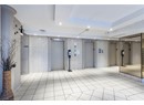 Building lobby featuring tile walls and recessed lighting