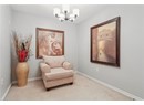 Sitting room featuring a chandelier, light colored carpet, and baseboards
