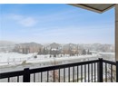 Snow covered back of property with a residential view