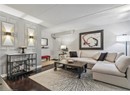 Living area featuring wood finished floors, baseboards, and a textured ceiling