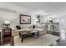 Living room featuring baseboards, dark wood-style flooring, and a textured ceiling