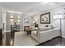 Living room with dark wood-style floors, baseboards, and a textured ceiling