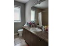 Full bath featuring tile patterned flooring, vanity, toilet, and curtained shower