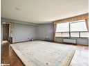 Empty room with baseboards and baseboard heating