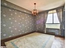 Empty room featuring a chandelier, baseboards, and a textured ceiling