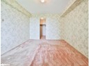 Carpeted empty room with wallpapered walls