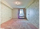 Unfurnished room featuring a textured ceiling, wallpapered walls, and carpet flooring