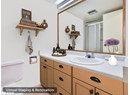 Full bath featuring a shower stall, vanity, toilet, and tile patterned flooring