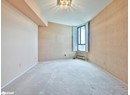 Empty room with carpet, a baseboard heating unit, and baseboards