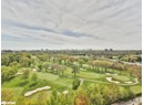 View of urban area featuring a golf club and a tree filled landscape