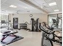 Workout area with a paneled ceiling and ceiling fan