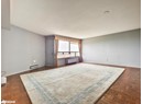 Unfurnished room with a baseboard radiator, baseboards, and a textured ceiling