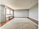 Spare room featuring radiator heating unit, a textured ceiling, and baseboards