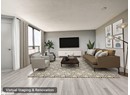 Living room with wood finished floors and a textured ceiling