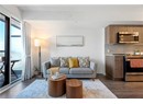 Living room featuring dark wood-type flooring and baseboards