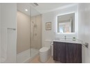 Full bath featuring toilet, a tile shower, and vanity