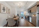 Dining space with a chandelier, dark wood-style flooring, track lighting, and baseboards