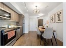 Kitchen featuring appliances with stainless steel finishes, backsplash, modern cabinets, light wood-style floors, and baseboards