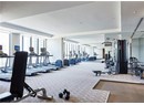 Workout area with carpet, a raised ceiling, and floor to ceiling windows