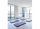 Exercise room featuring floor to ceiling windows, wood finished floors, and plenty of natural light