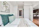 Bedroom with light wood-style flooring and ensuite bath