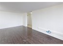 Spare room featuring ornamental molding, wood finished floors, and baseboards