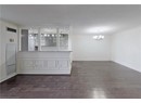 Spare room featuring a chandelier, crown molding, dark wood-style floors, and baseboards